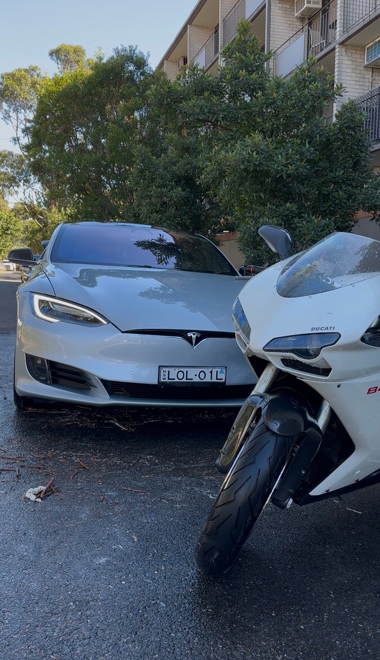 White Tesla and Ducati motorcycle